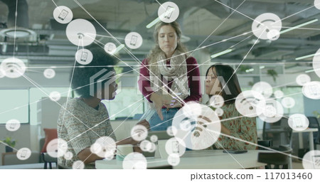 Image of network of connections with icons over diverse female colleagues using tablet in office 117013460