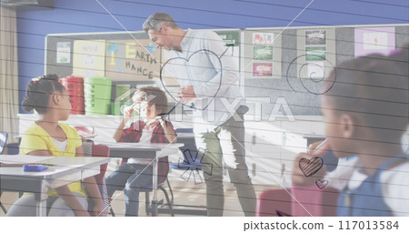 Multiple icons over white lined paper against caucasian male teacher teaching in the class at school Multiple icons over white lined paper against caucasian male teacher teaching in the class at school 117013584