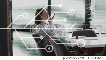 Image of circuit board and data processing over caucasian businesswoman in office 117013658