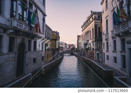 A bridge over a canal in Venice, the city of water, early in the morning 117013660