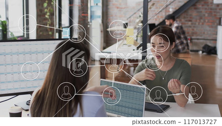 Image of digital icons with connections over diverse business people in office 117013727