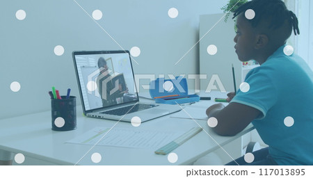 Image of white spots over african american boy having image call on laptop at home 117013895
