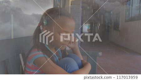 Composite image of rainfall and thunderstorms against stressed african american girl at school 117013959