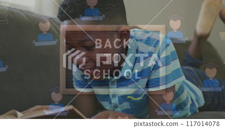 Image of back to school text over african american boy reading 117014078