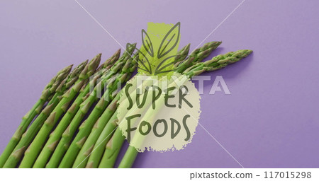 Super foods text image over asparagus on purple background Super foods text image over asparagus on purple background 117015298