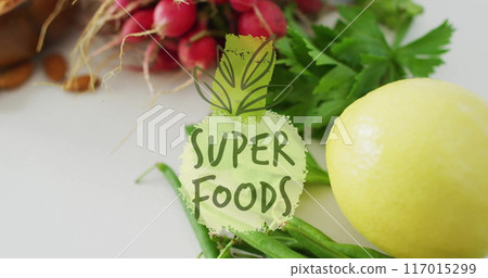 Super Foods text image over fresh vegetables including radishes and parsley 117015299