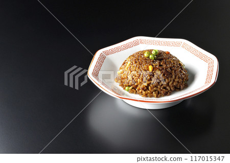 Burnt soy sauce fried rice photographed against a black background Burnt soy sauce fried rice photographed against a black background 117015347