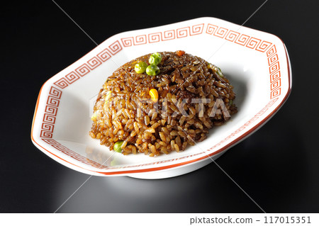 Burnt soy sauce fried rice photographed against a black background 117015351