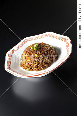 Burnt soy sauce fried rice photographed against a black background Burnt soy sauce fried rice photographed against a black background 117015383