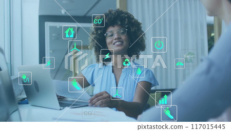 Image of ecology icons over diverse colleagues using laptop and discussing work in office Image of ecology icons over diverse colleagues using laptop and discussing work in office 117015445