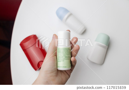 Choice of deodorant or antiperspirant. Looking at the jars on the table. Safe or critical deodorant ingredients Choice of deodorant or antiperspirant. Looking at the jars on the table. Safe or critical deodorant ingredients 117015839