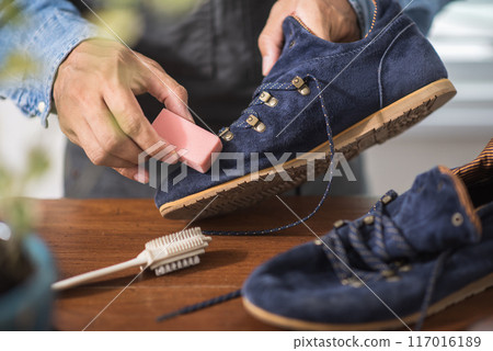 Cleaning the suede shoes. 117016189