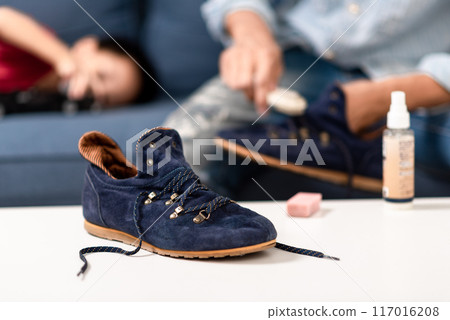 Cleaning the suede shoes. 117016208