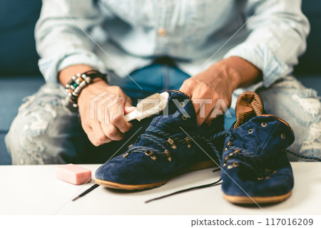 Cleaning the suede shoes. 117016209