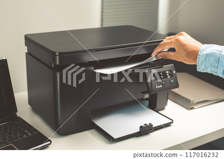 The man using the laser printer. 117016232