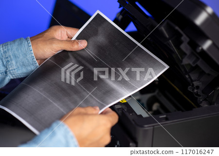 The man repairing laser printer. 117016247