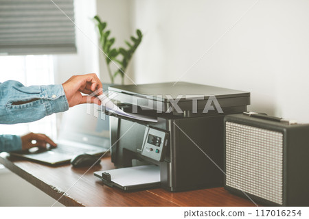 The man using the laser printer. 117016254