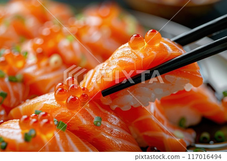 A plate of sushi with chopsticks in hand 117016494