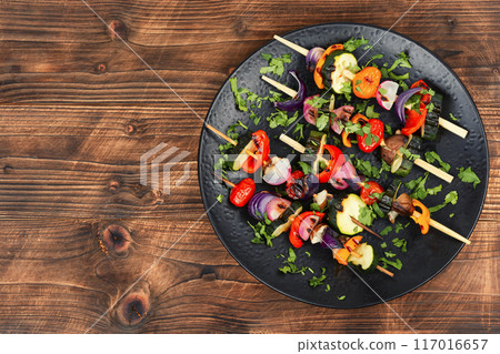 Grilled vegetables on skewers, space for text. 117016657