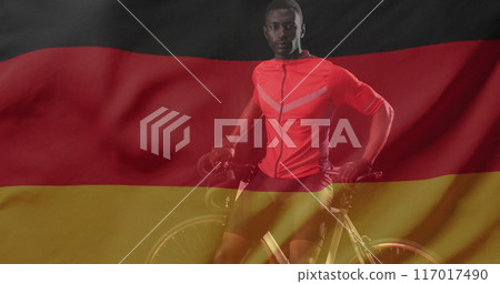 Image of flag of germany over african american male cyclist 117017490