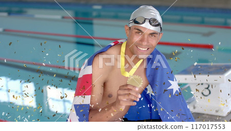 Image of confetti over biracial male swimmer holding medal with flag of australia 117017553