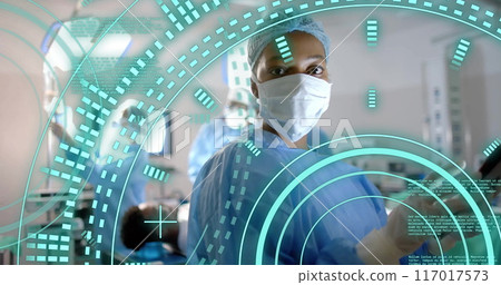 Image of scope scanning and data processing over african american surgeon in operating theatre 117017573