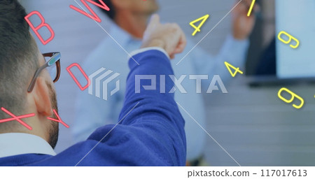 Image of numbers and letters over diverse business people in office Image of numbers and letters over diverse business people in office 117017613