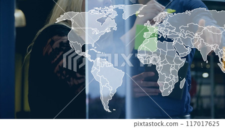 Image of world map over diverse business people in office 117017625