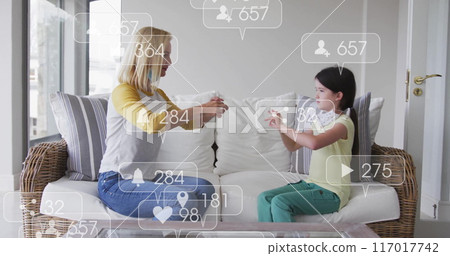 Social media interaction icons image over woman and child playing hand game 117017742