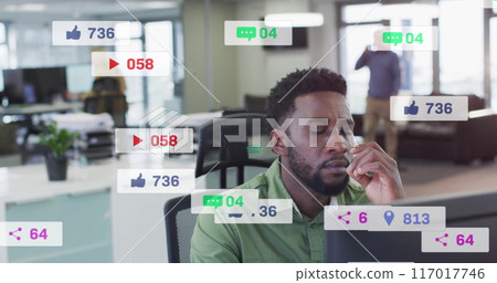 Social media notifications image over man working in modern office 117017746