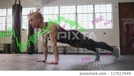 Performing push-ups, woman exercising over financial data processing image 117017849