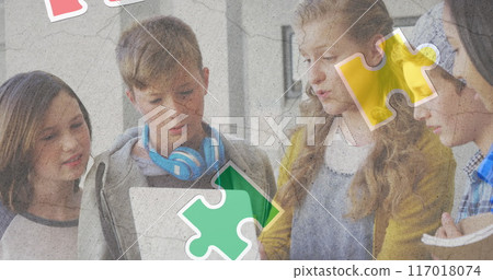 Jigsaw puzzle and human head icon over diverse group of students using laptop at school 117018074