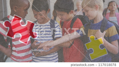 Jigsaw puzzle and human head icon against diverse group of boys using smartphone at school Jigsaw puzzle and human head icon against diverse group of boys using smartphone at school 117018078