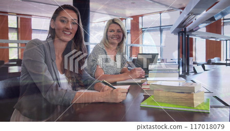 Image of globe and programming language over smiling caucasian teachers sitting in school Image of globe and programming language over smiling caucasian teachers sitting in school 117018079