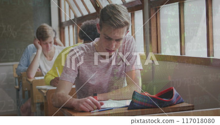 Image of trading board and graph moving over caucasian teenage boy studying in classroom 117018080