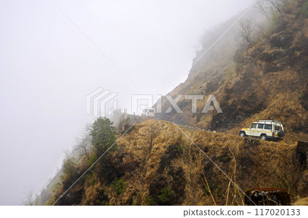 Car moving upwards Slope in Mountain Zig Zag Road of Silk Route Sikkim Car moving upwards Slope in Mountain Zig Zag Road of Silk Route Sikkim 117020133