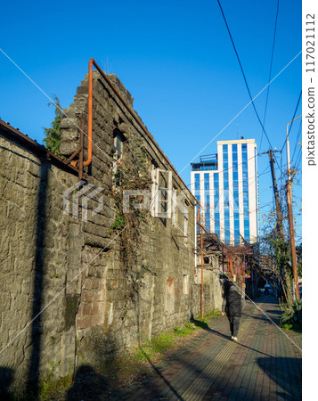 Window in a destroyed building. Remained a wall from the house. The concept of demolition of dilapidated housing. 117021112