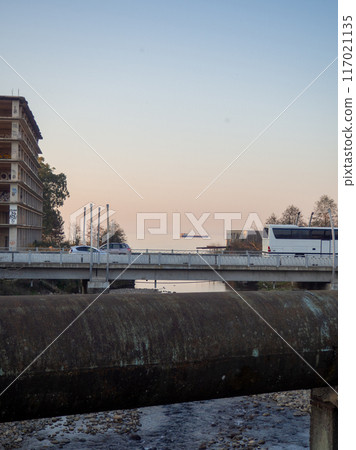 Heating main over the stream. Industry and nature.  Concrete rapids on the river 117021135