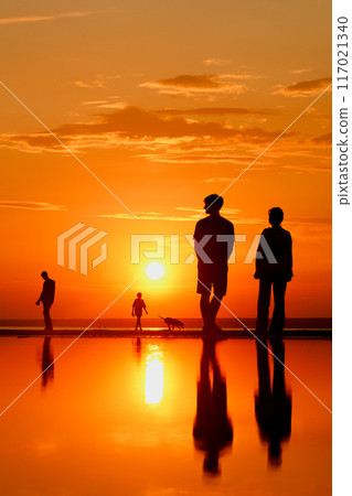 Silhouettes of people against sky seascape sunset sky on sea or ocean 117021340
