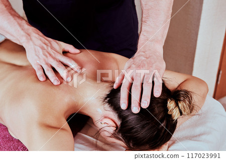 Massage therapy for back and neck pain for young women 26 years old. Massage therapy for back and neck pain for young women 26 years old. 117023991