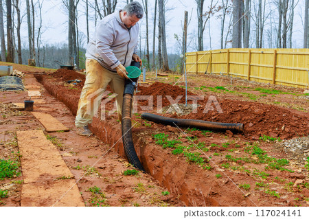 Installation storm drainage drain pipes in trench drains for drainage of rain water 117024141