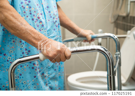 Asian elderly woman patient use walker and toilet bathroom handle security in nursing hospital, healthy strong medical. 117025191