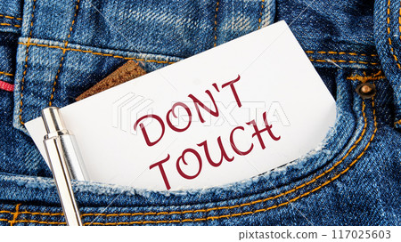 Do not Touch ME text written on a piece of paper from a jeans pocket 117025603