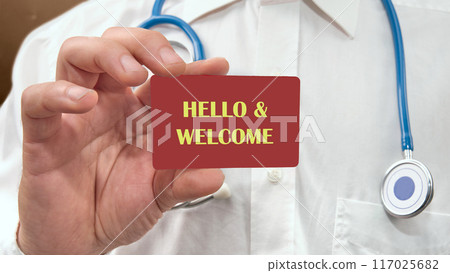 Hello and welcome symbol. Concept words Hello and welcome on a red business card, a card in a man's hand 117025682