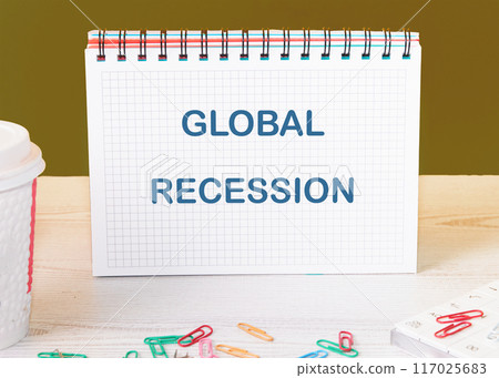 The concept of economic crisis. GLOBAL RECESSION word in a checkered notebook on the table The concept of economic crisis. GLOBAL RECESSION word in a checkered notebook on the table 117025683