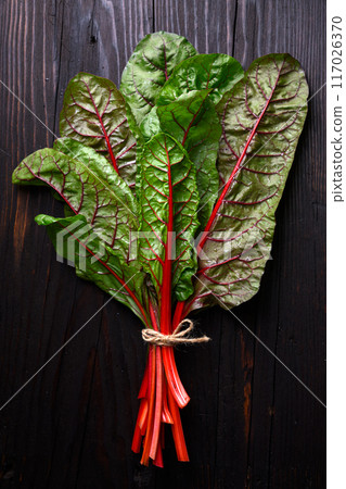 Bunch of organic red chard on a rustic wooden background 117026370