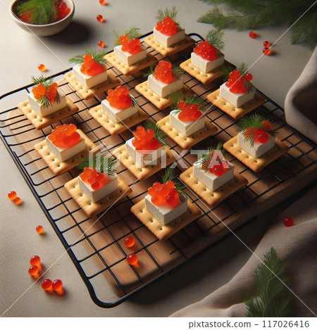 Nine crackers topped with cream cheese, salmon roe, and dill on parchment paper 117026416