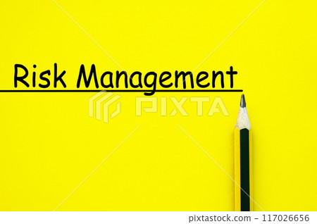 Risk management text written on yellow paper background 117026656