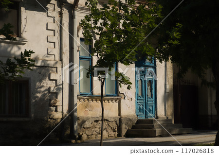 blue old wooden door in an old house on a sunny day blue old wooden door in an old house on a sunny day 117026818