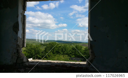 view from the old window of green meadows and blue sky with white fluffy clouds view from the old window of green meadows and blue sky with white fluffy clouds 117026965